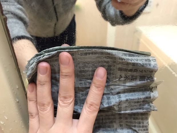 鏡を濡らした新聞紙で拭く