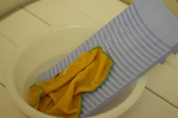 洗濯板でタオルを洗う様子