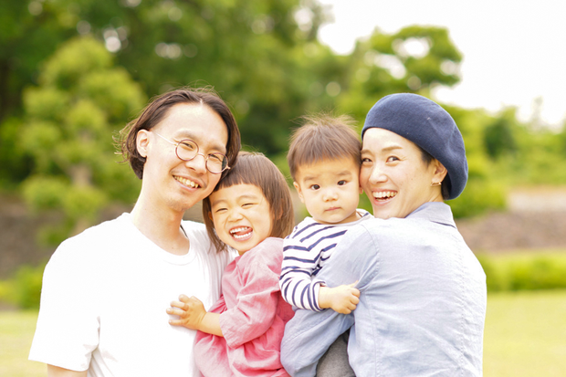 娘と息子を抱いて笑う夫婦